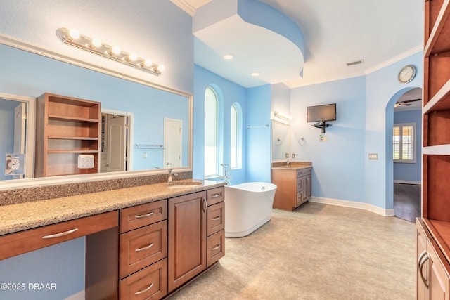 20 Promenade At Lionspaw, Daytona Beach, FL 32124 - full bathroom with two vanities, ornamental molding, a sink, baseboards, and a soaking tub