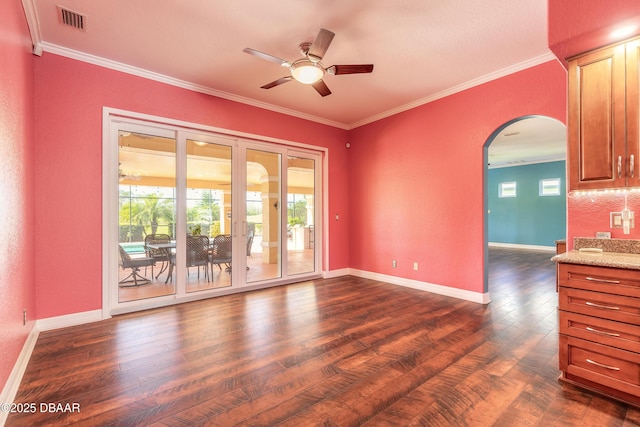 20 Promenade At Lionspaw, Daytona Beach, FL 32124 - empty room featuring visible vents, ornamental molding, dark wood finished floors, arched walkways, and ceiling fan