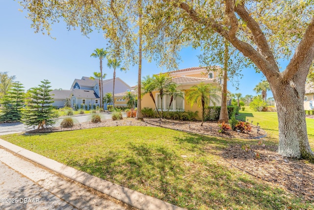 20 Promenade At Lionspaw, Daytona Beach, FL 32124 - view of front of property featuring stucco siding, a front lawn, and a tile roof