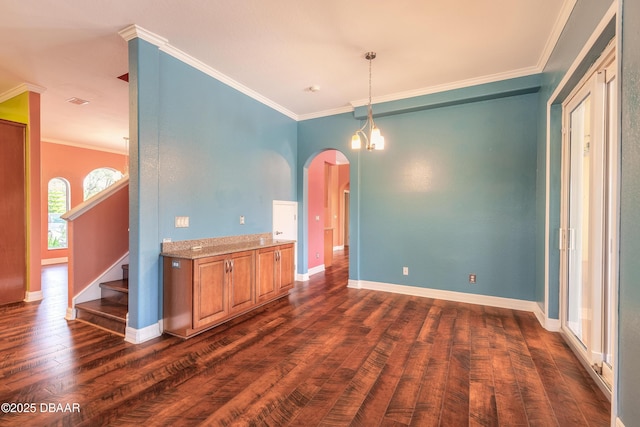 20 Promenade At Lionspaw, Daytona Beach, FL 32124 - spare room featuring crown molding, baseboards, stairway, dark wood-style floors, and arched walkways