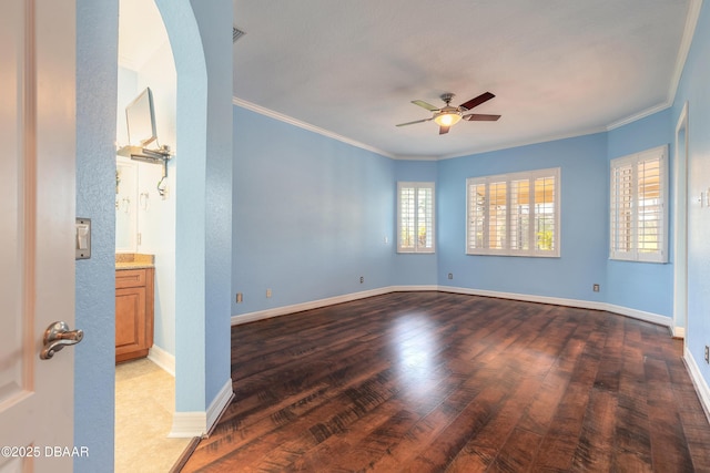 20 Promenade At Lionspaw, Daytona Beach, FL 32124 - empty room featuring wood finished floors, a ceiling fan, baseboards, arched walkways, and ornamental molding