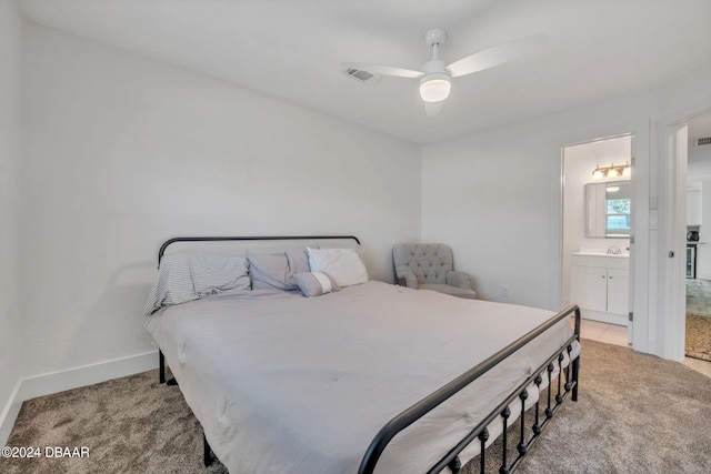 bedroom with light carpet, ceiling fan, and ensuite bathroom