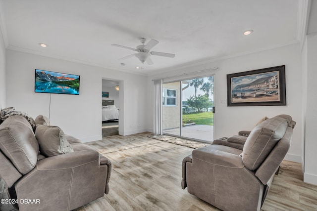 living room featuring ceiling fan, crown molding, and light hardwood / wood-style flooring