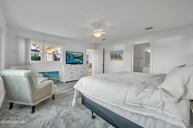 bedroom with ensuite bathroom, carpet, and ceiling fan