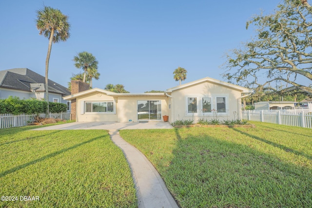 back of property with a patio and a lawn