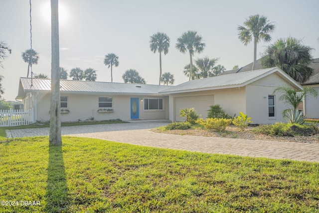 ranch-style house with a garage and a front yard