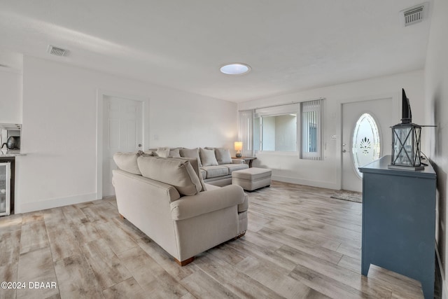 living room with wine cooler and light hardwood / wood-style flooring