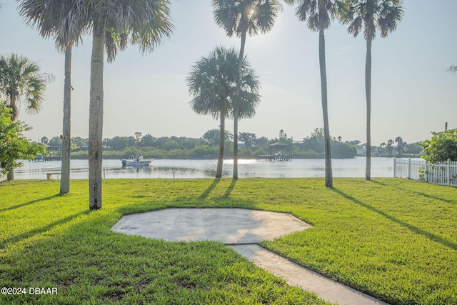 surrounding community featuring a water view and a yard