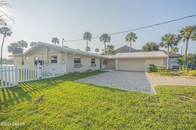 ranch-style house with a garage and a front yard