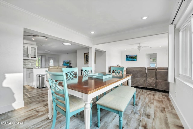 dining room with ceiling fan, light wood-type flooring, and ornamental molding