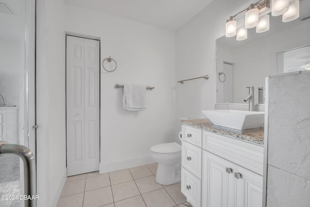 bathroom featuring tile patterned flooring, vanity, and toilet