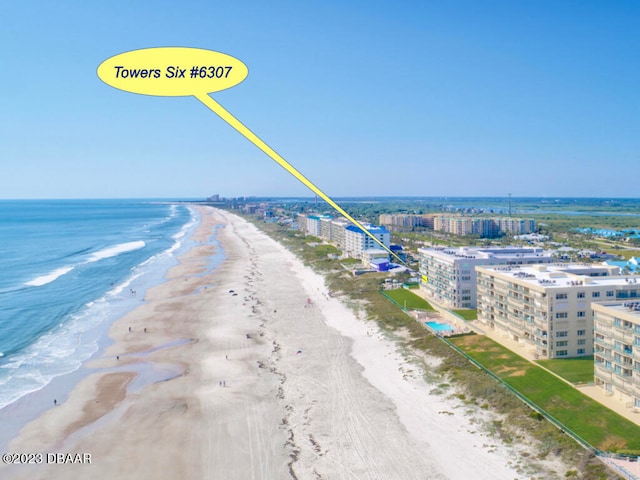 drone / aerial view featuring a water view and a beach view