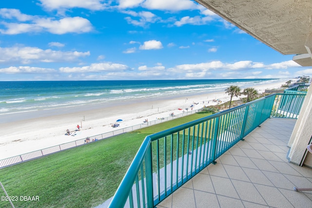 balcony with a beach view and a water view