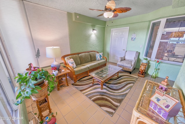 living room with a textured ceiling and ceiling fan