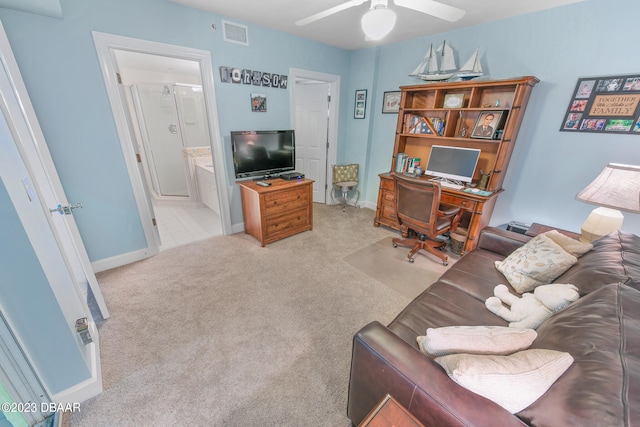 carpeted office space with ceiling fan