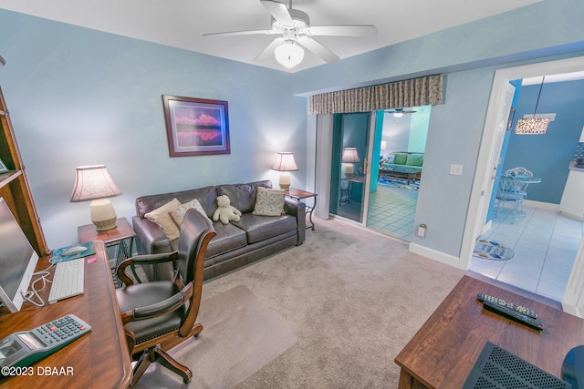 living room with carpet and ceiling fan with notable chandelier