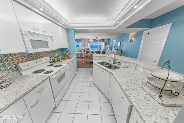 kitchen featuring a chandelier, white appliances, sink, and white cabinets