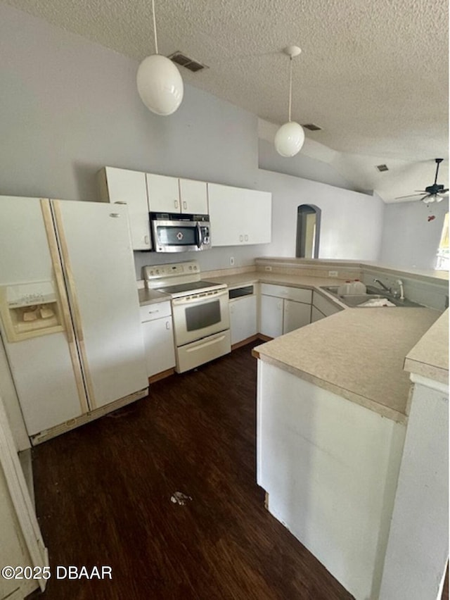 1362 Comerwood Dr, Deltona, FL 32738 - kitchen featuring white appliances, a textured ceiling, dark wood finished floors, white cabinets, and hanging light fixtures