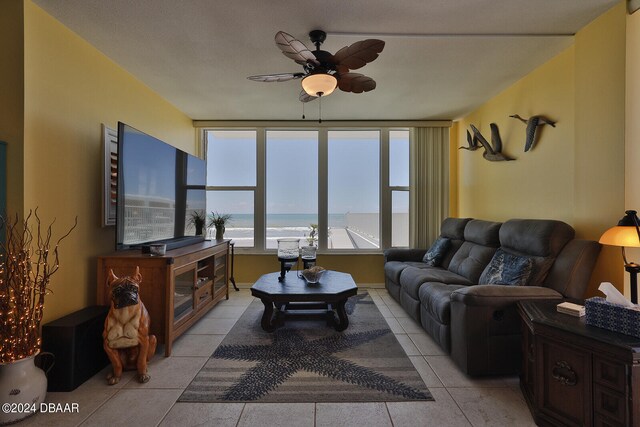 tiled living room featuring ceiling fan