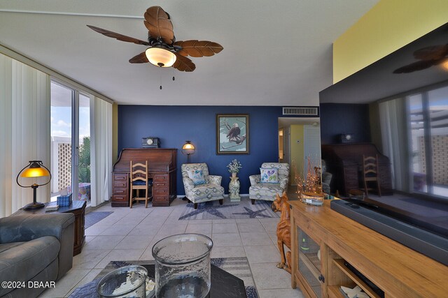 tiled living room with ceiling fan