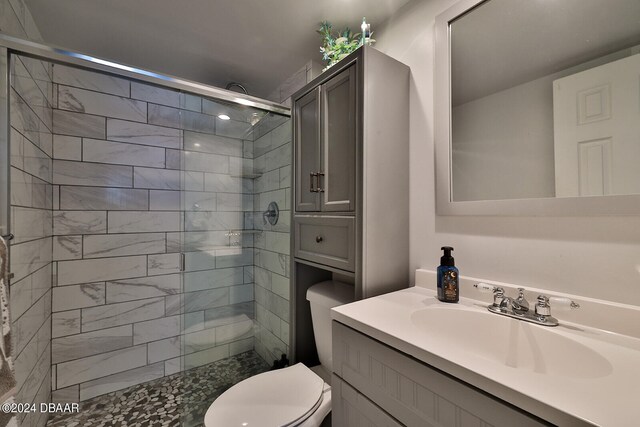 bathroom featuring vanity, toilet, and an enclosed shower