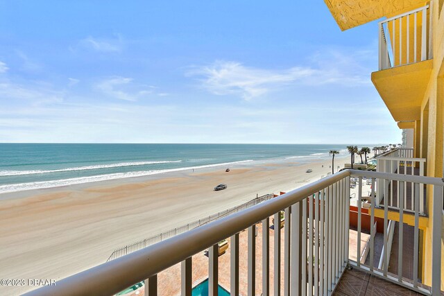 balcony with view of water and beach