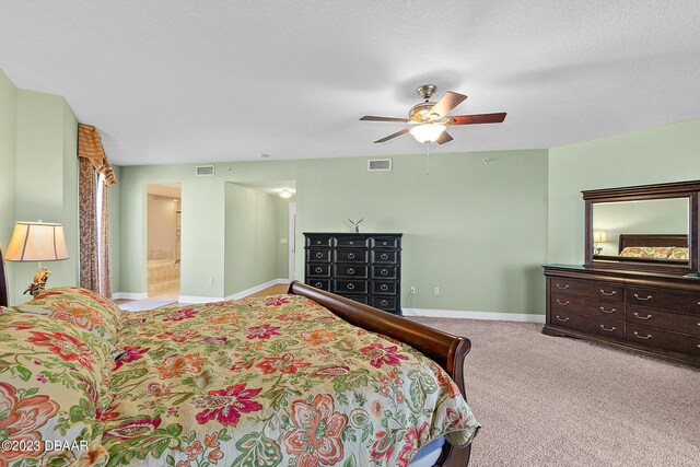 bedroom featuring baseboards, carpet flooring, ceiling fan, and ensuite bathroom