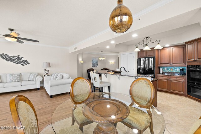 dining space with crown molding, ceiling fan, light wood-style floors, and recessed lighting