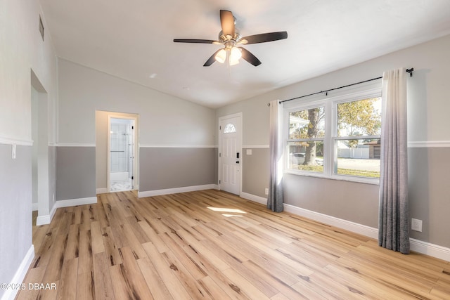 interior space featuring light hardwood / wood-style floors, vaulted ceiling, and ceiling fan