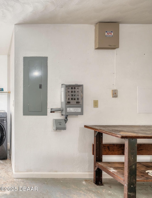 interior space with washer / dryer, concrete flooring, and electric panel