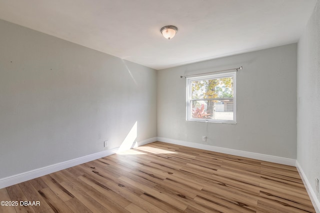 unfurnished room with light hardwood / wood-style flooring