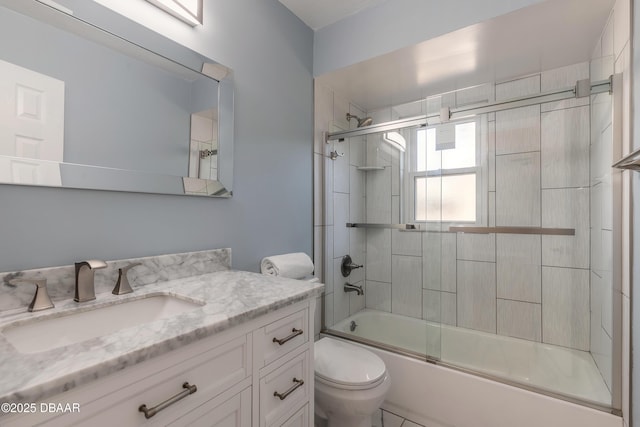 full bathroom featuring vanity, toilet, and combined bath / shower with glass door