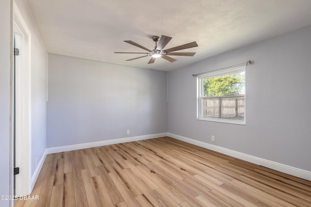 empty room with ceiling fan and light hardwood / wood-style flooring