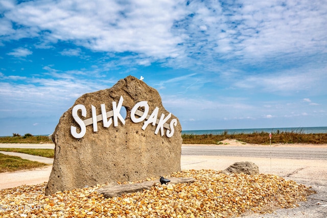 community sign with a water view