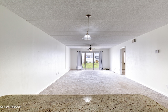 spare room with carpet and ceiling fan