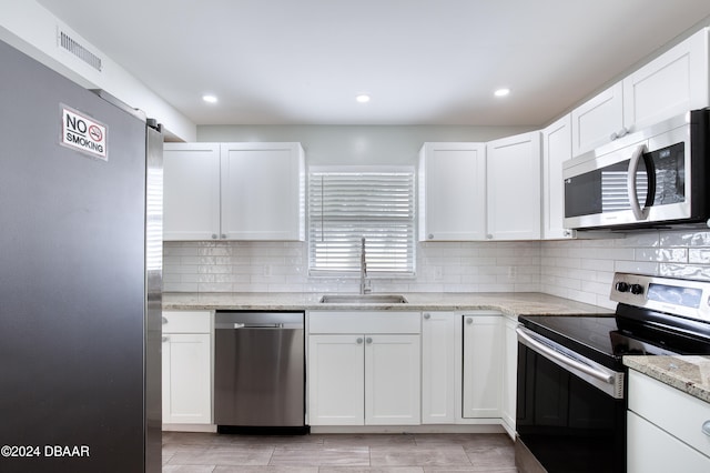 kitchen with white cabinets, sink, and stainless steel appliances