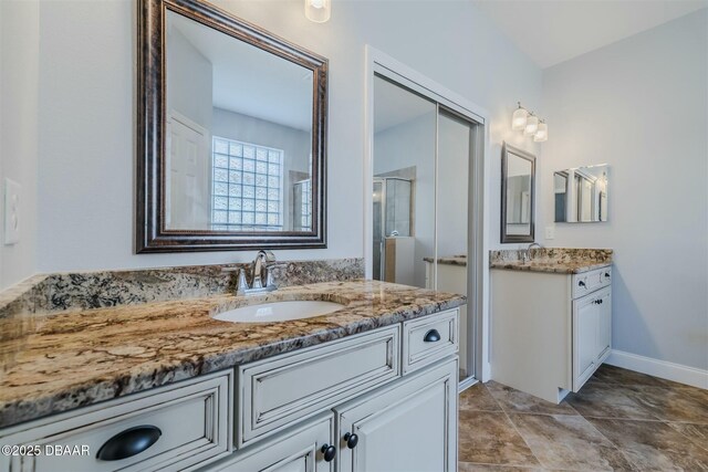 bathroom featuring vanity and a shower with door