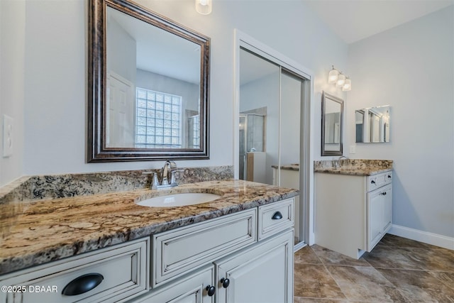 bathroom featuring vanity and a shower with shower door