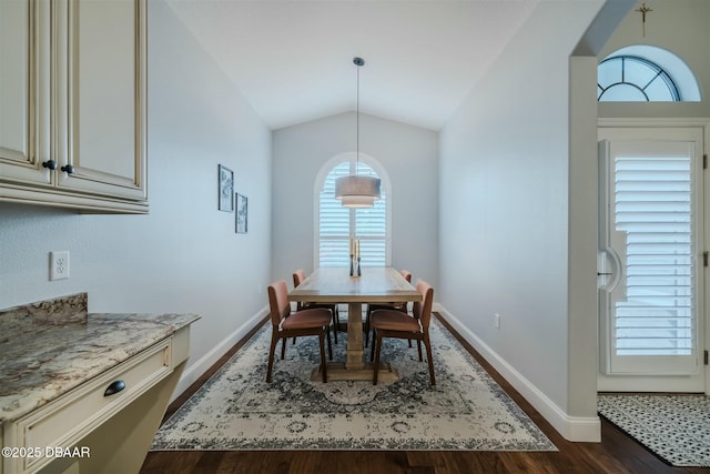 dining area with dark wood-type flooring and lofted ceiling