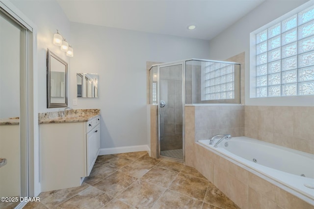 bathroom with vanity, independent shower and bath, tile patterned floors, and a healthy amount of sunlight