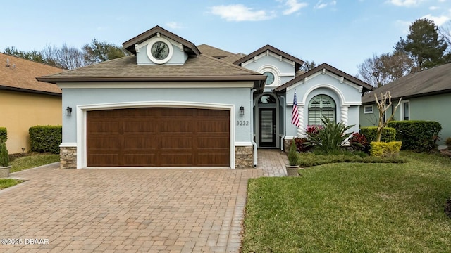 view of front of property with a front yard and a garage