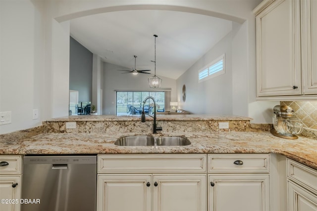 kitchen with lofted ceiling, sink, light stone counters, dishwasher, and decorative light fixtures