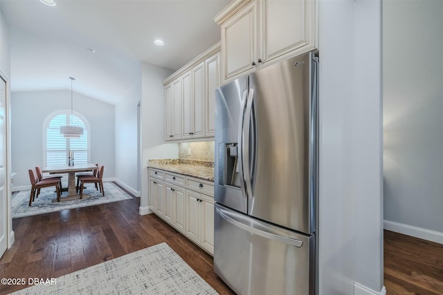 kitchen featuring dark hardwood / wood-style flooring, stainless steel fridge, and lofted ceiling