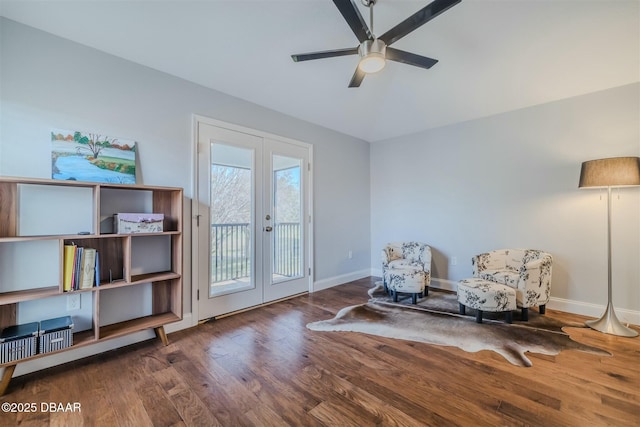 sitting room with ceiling fan, french doors, and wood-type flooring