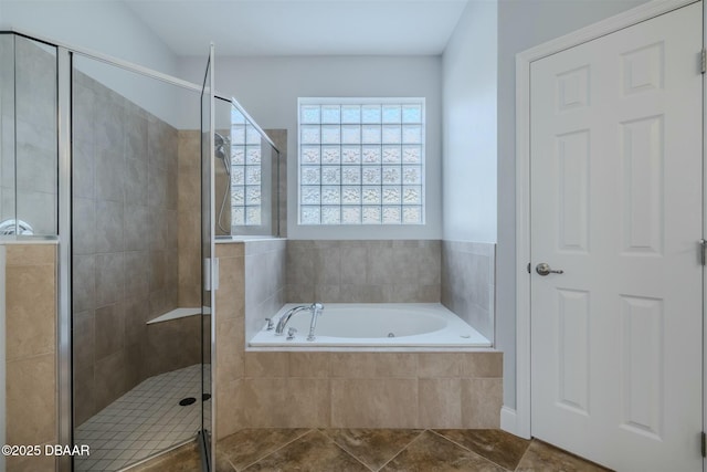 bathroom with independent shower and bath and tile patterned flooring