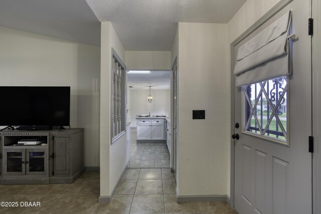 1408 Mollie Rd, Daytona Beach, FL 32114 - foyer entrance with a textured wall, a textured ceiling, and light tile patterned flooring