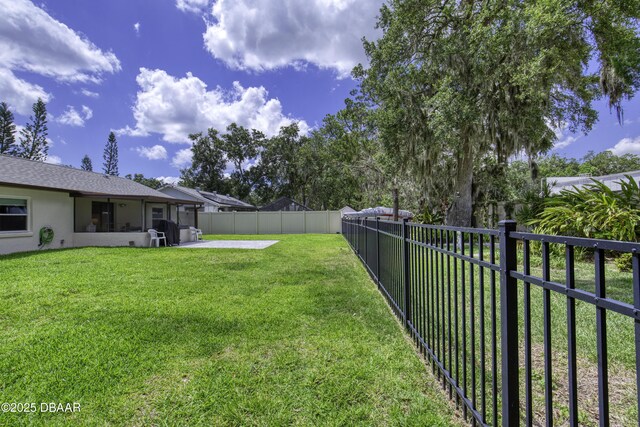 1408 Mollie Rd, Daytona Beach, FL 32114 - fenced backyard with a patio area