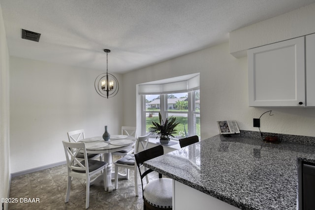 1408 Mollie Rd, Daytona Beach, FL 32114 - dining area featuring a chandelier and a textured ceiling