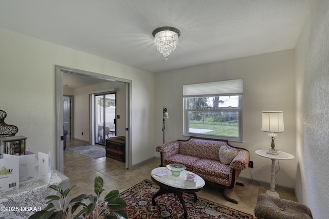 1408 Mollie Rd, Daytona Beach, FL 32114 - living room featuring light tile patterned floors, a textured wall, and a chandelier