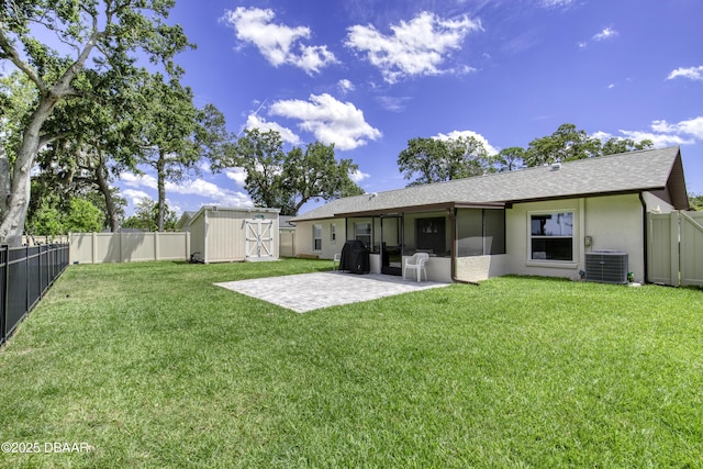 1408 Mollie Rd, Daytona Beach, FL 32114 - rear view of house featuring a shed, a patio, a fenced backyard, and a shingled roof